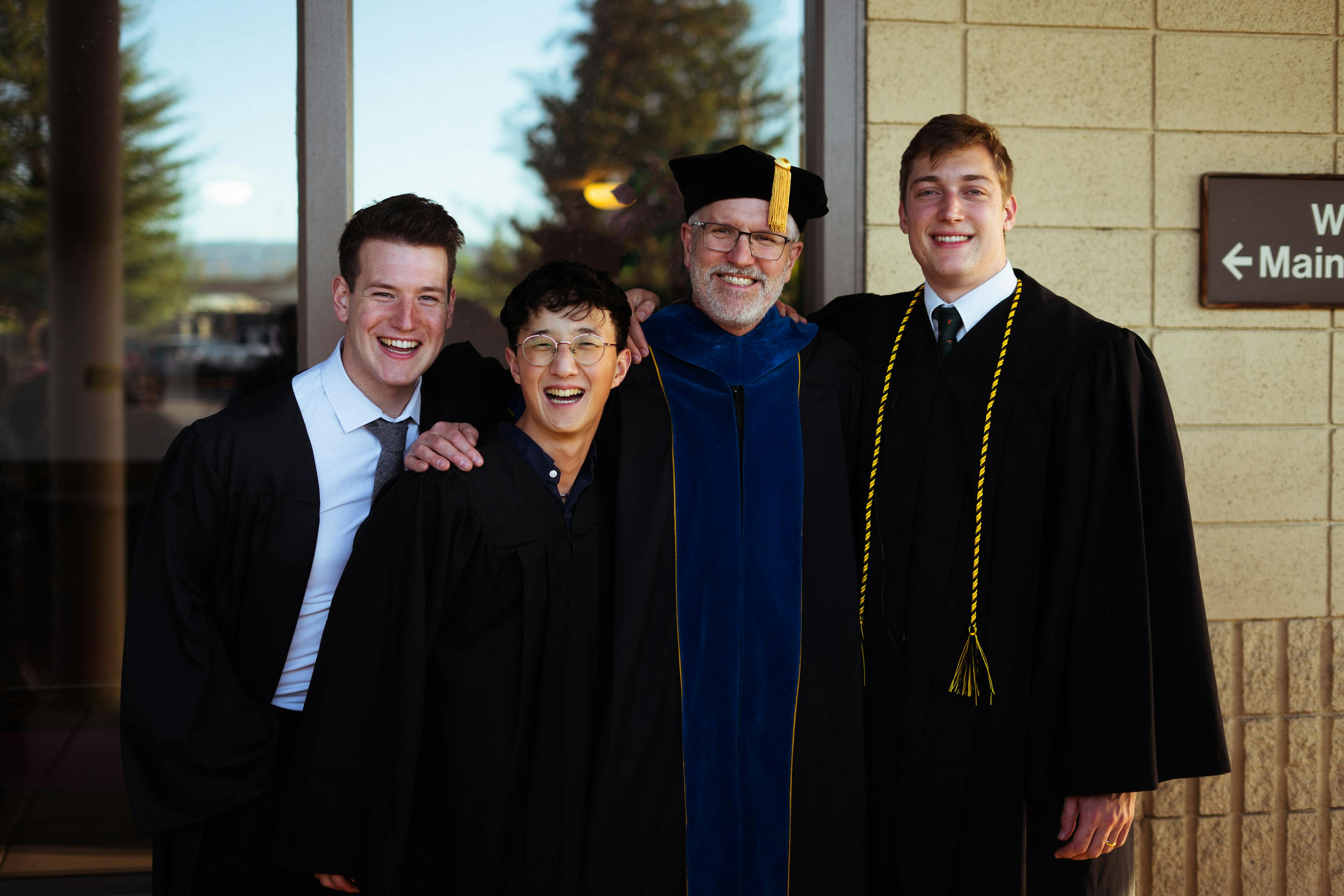 Commencement Grads with Dr. Wilson - Class of 2023 - Joshua Lee, Nate Miller, and Talis Meyer